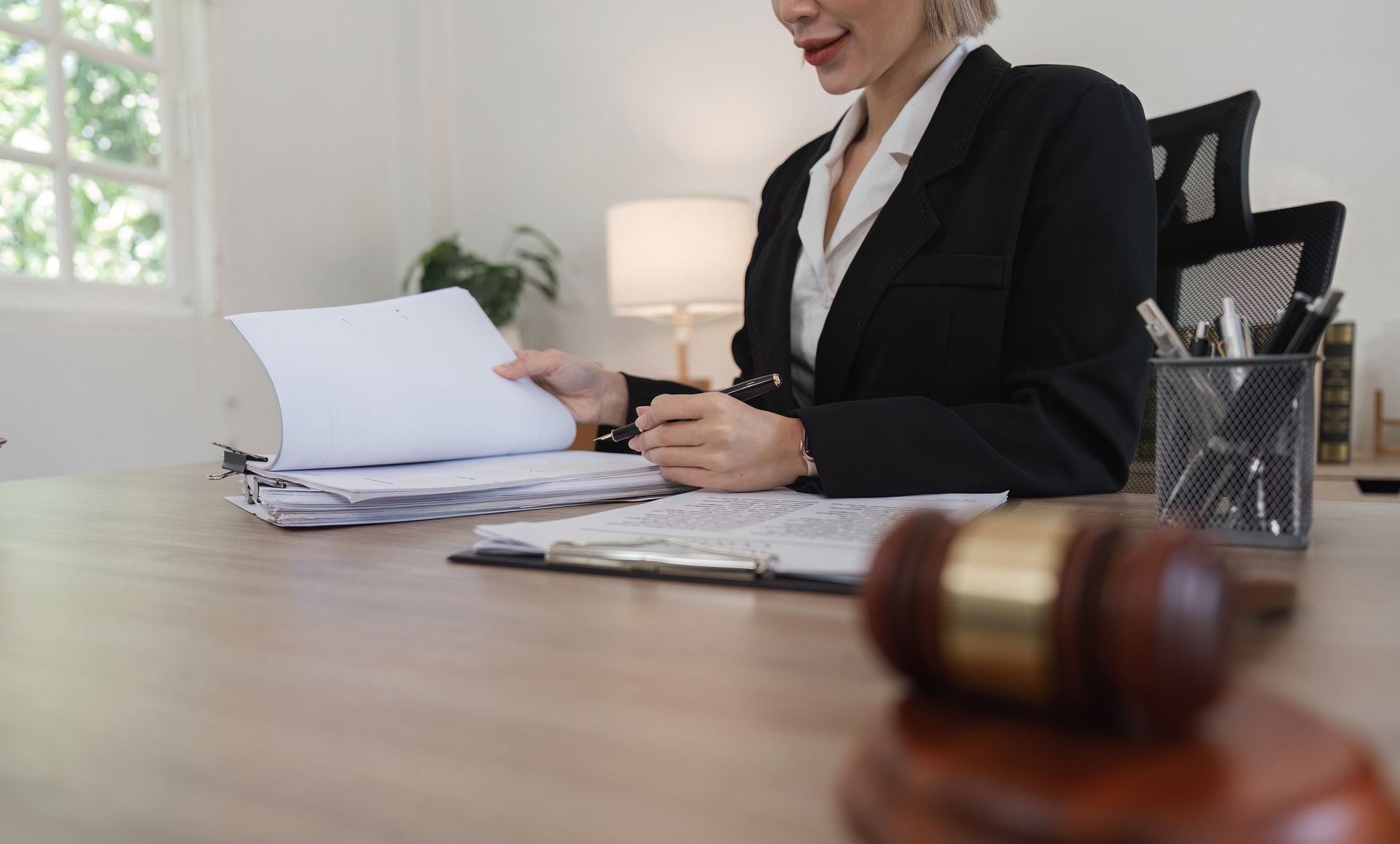 Estate planning attorney reviewing documents in a modern law office.