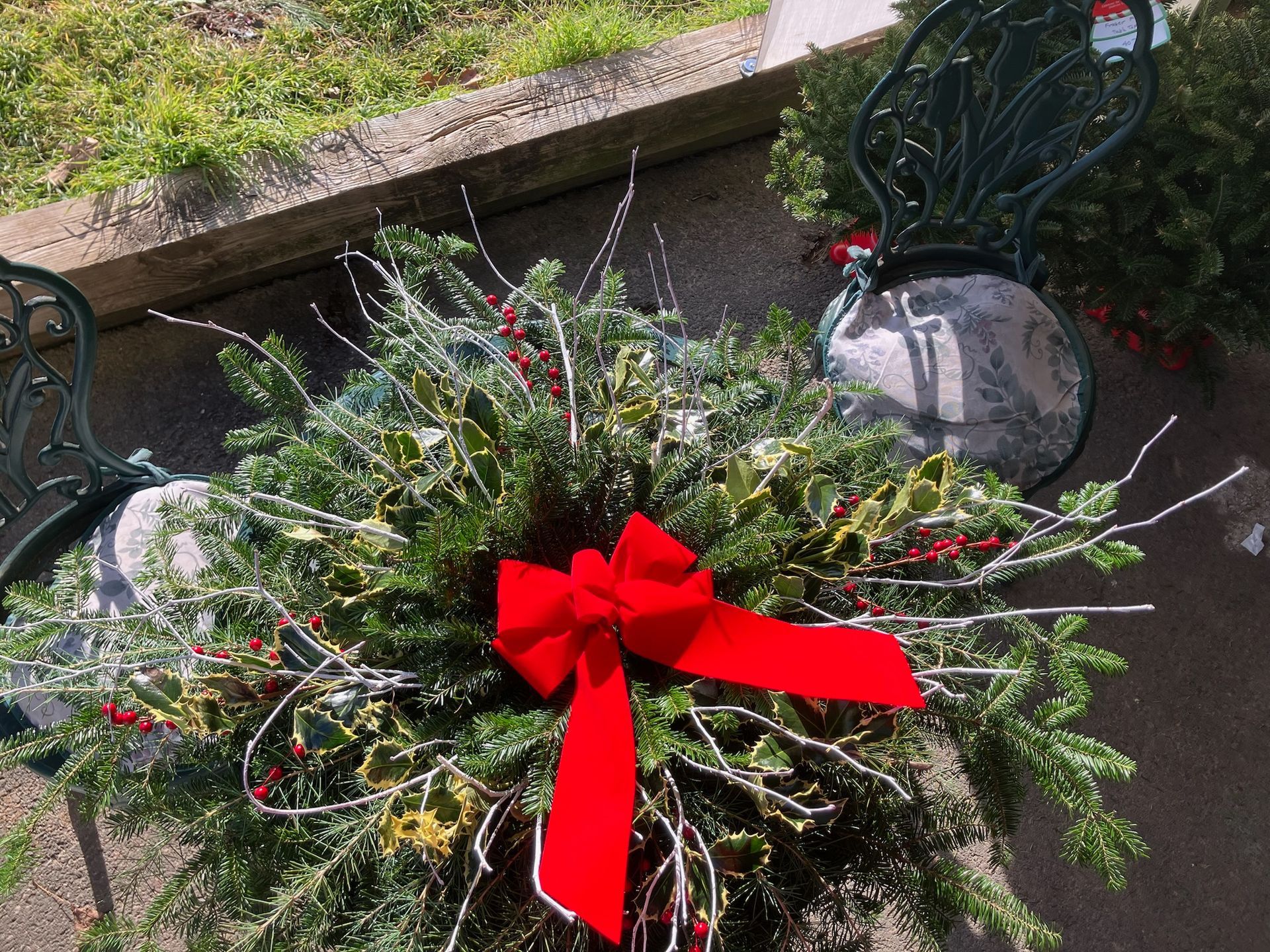 A christmas wreath with a red bow is sitting on a table.