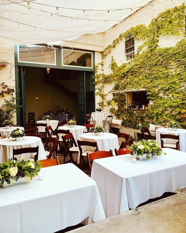 A patio with tables and chairs set up for a party