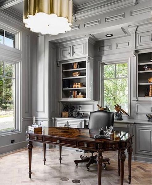 A home office with a desk, chair and shelves