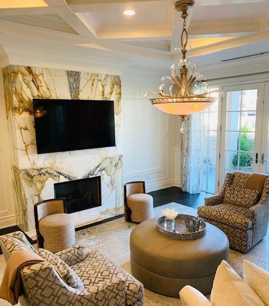 A living room with a fireplace and a flat screen tv