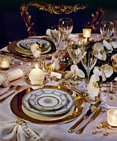 A table set with plates glasses and candles