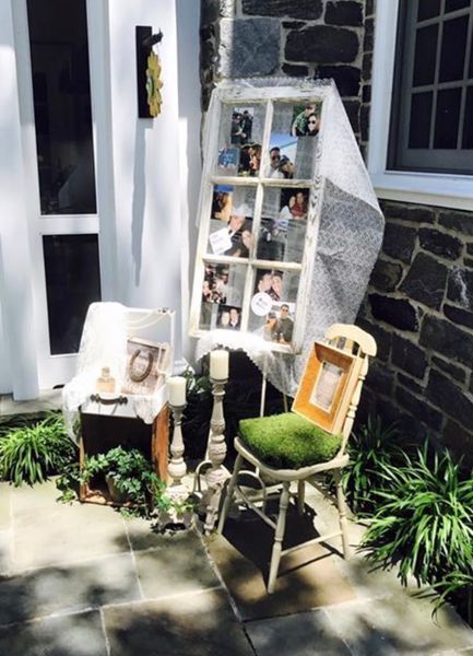 A chair is sitting in front of a window with pictures on it