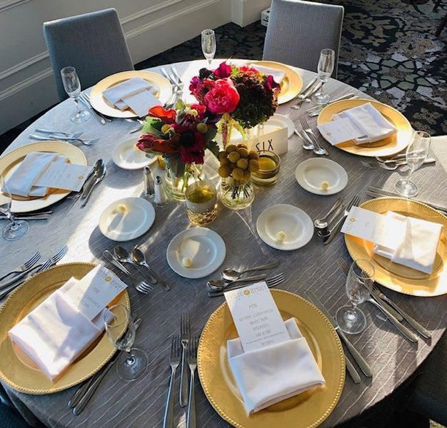 A round table with plates and utensils on it