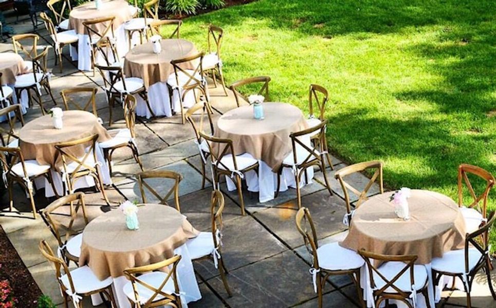 A patio with tables and chairs set up for a party