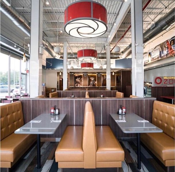The inside of a restaurant with tables and benches