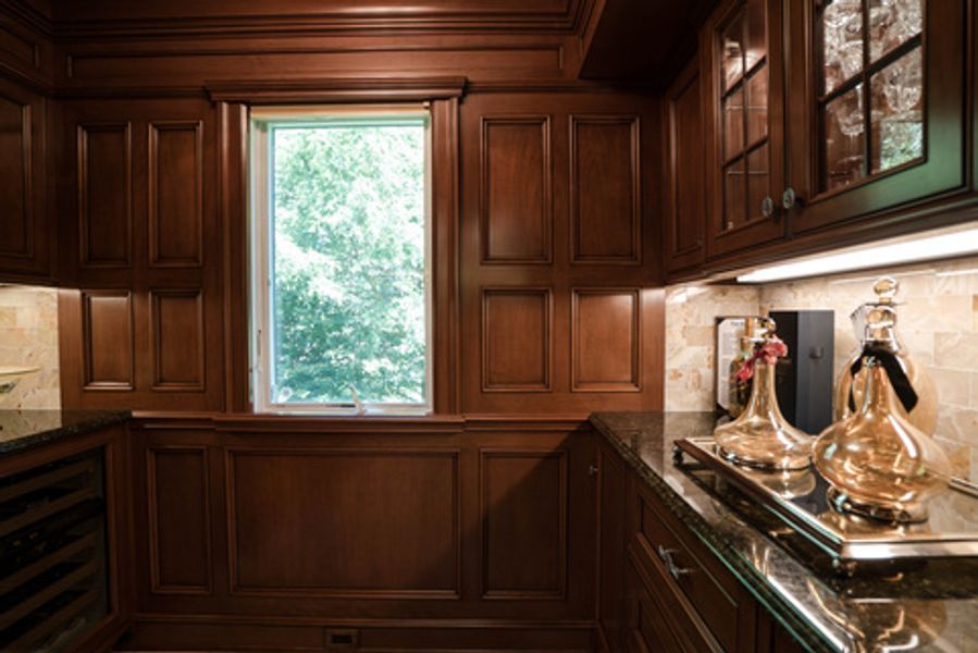 A kitchen with wooden cabinets and a window