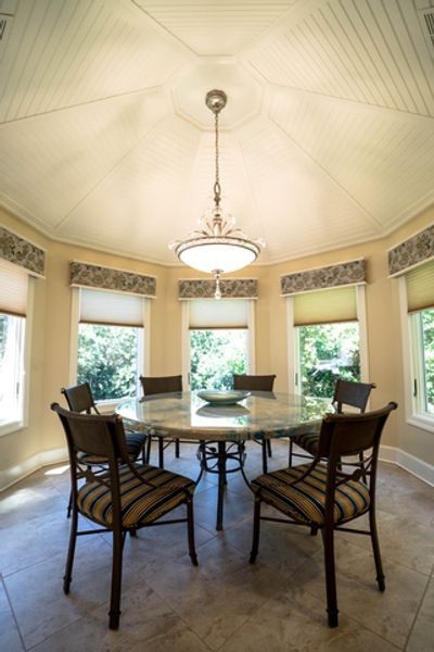 A dining room with a round table and chairs