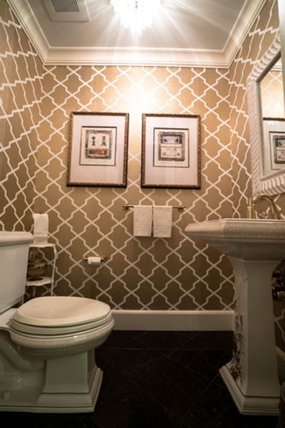 A bathroom with a toilet, sink and mirror