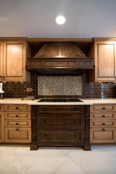 A kitchen with wooden cabinets and a stove top oven