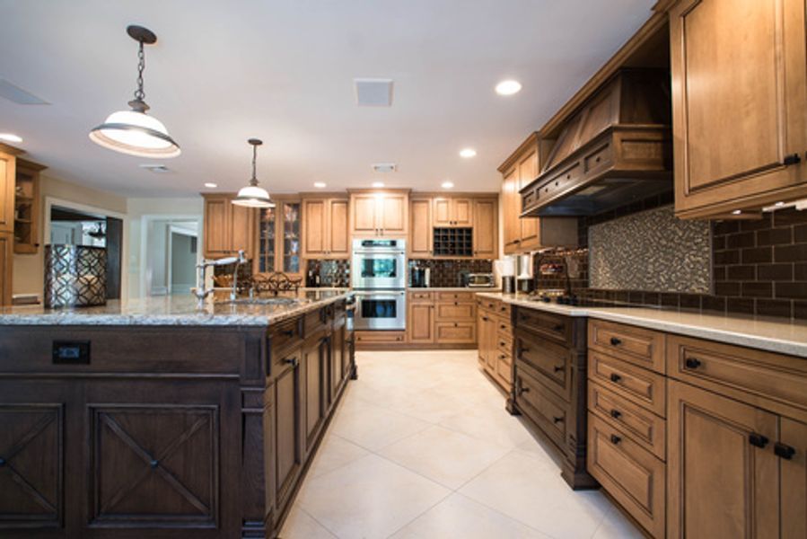 A large kitchen with wooden cabinets and stainless steel appliances