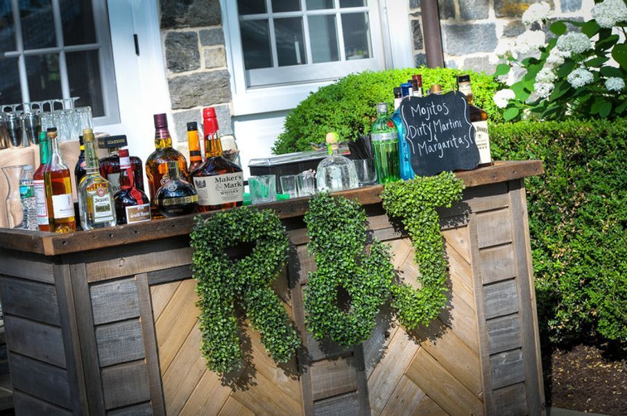 A wooden bar with bottles of liquor on it