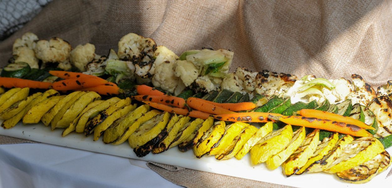 A white plate topped with a variety of grilled vegetables