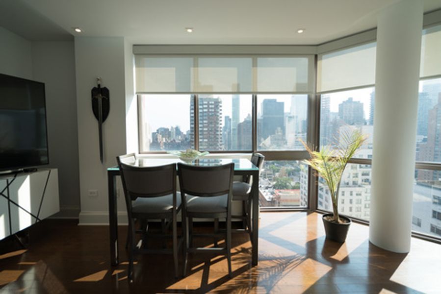 A living room with a table and chairs and a television
