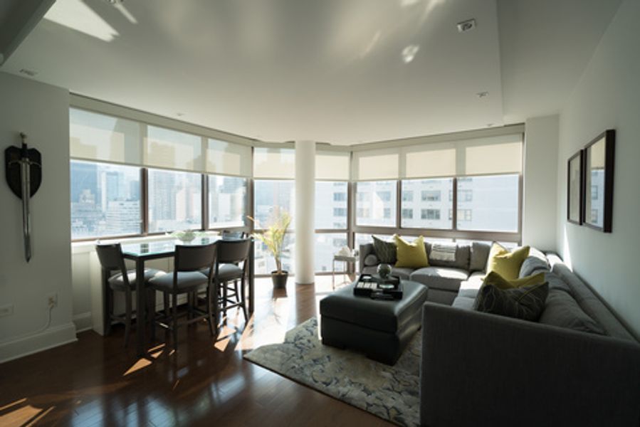 A living room with a couch, table and chairs