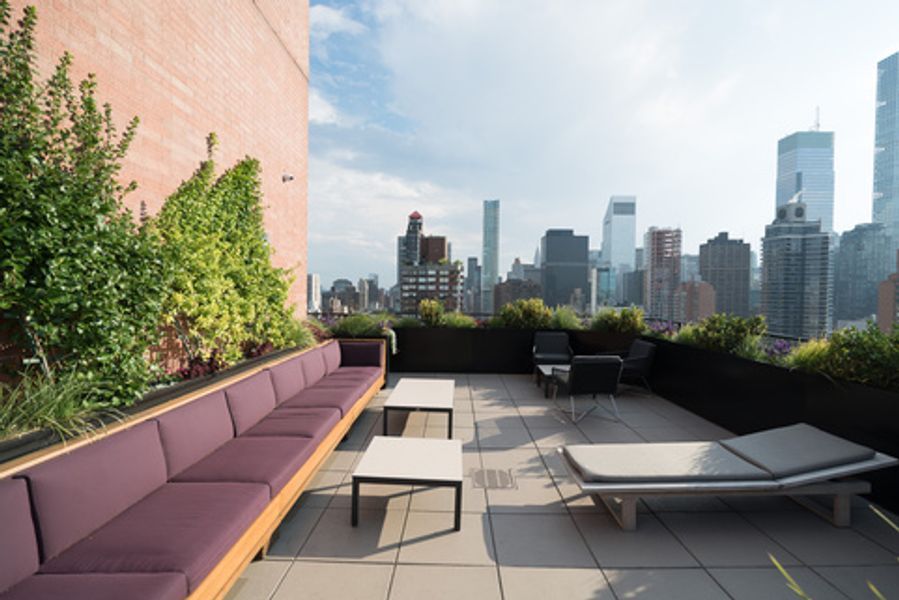 A rooftop terrace with a view of the city skyline