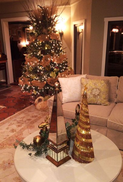 A christmas tree is sitting on a table in a living room next to a couch