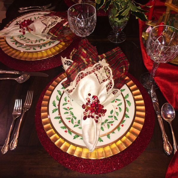 A table set for a christmas dinner with plates and silverware