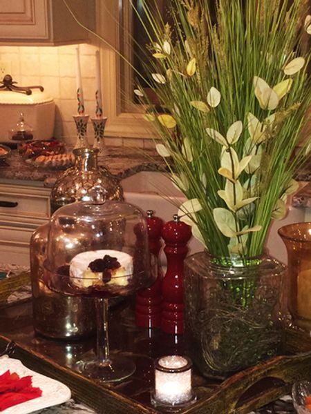 A table with a vase of flowers and candles on it