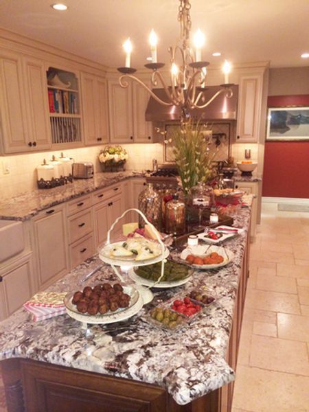 A kitchen with plates of food on the counter and a chandelier