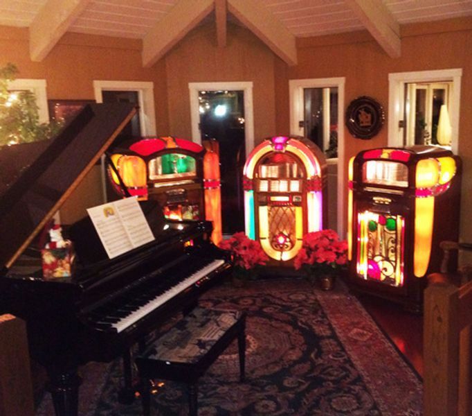 A piano and jukebox are in a living room