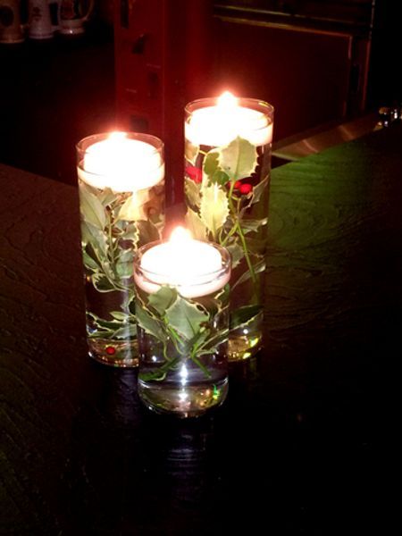 Three candles are floating in a glass of water