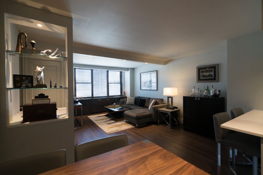 A living room with a table and chairs in it