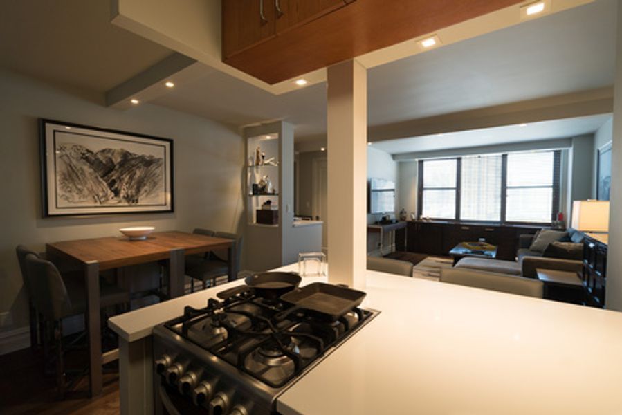 A kitchen with a stove top oven and a table