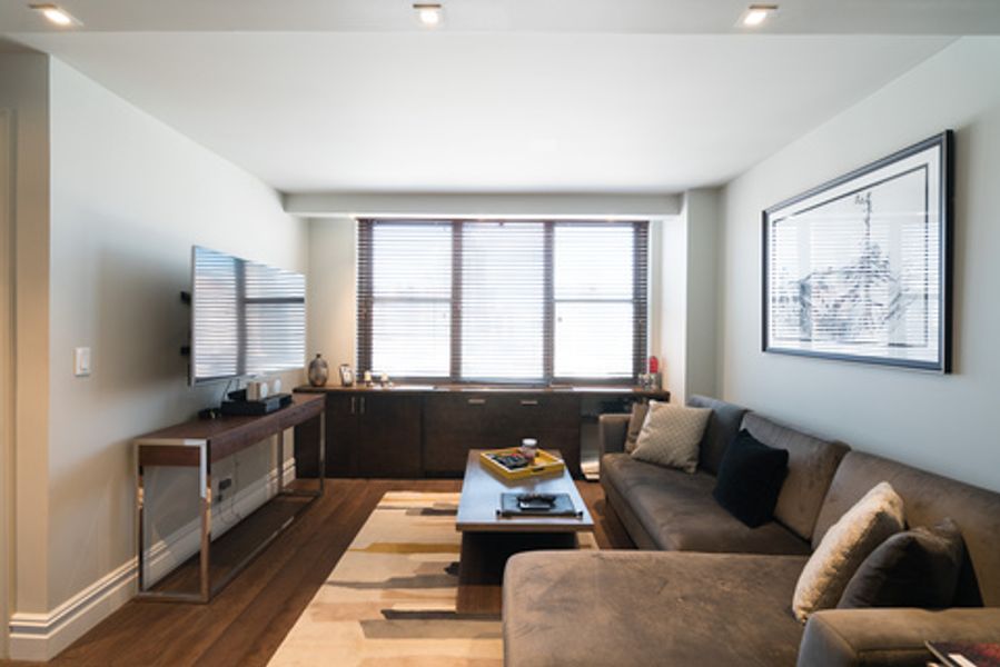 A living room with a couch and a flat screen tv