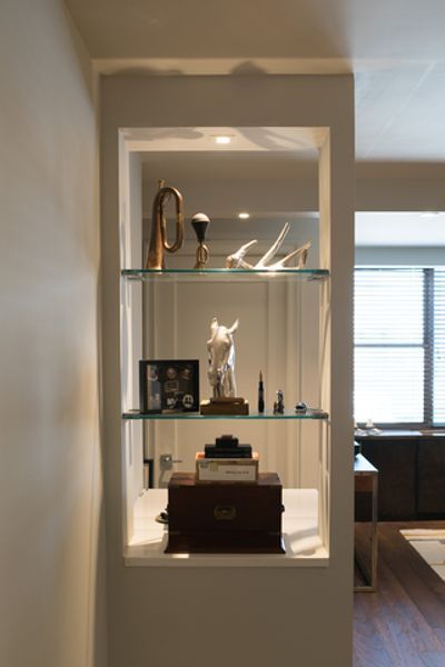 A shelf with a statue of a horse on it