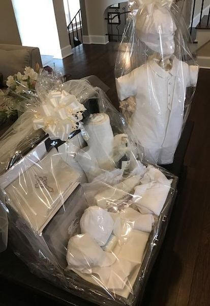 A bunch of white clothes are wrapped in plastic on a table