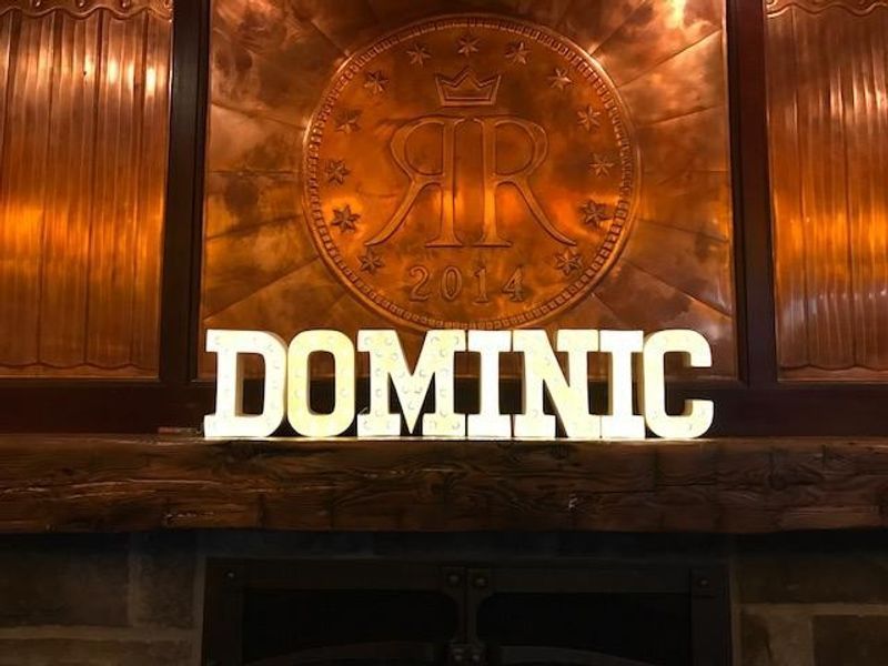 A sign that says dominic is sitting on a mantle