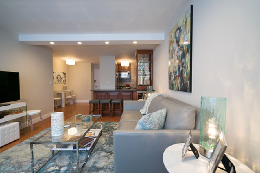 A living room with a couch, coffee table, and television