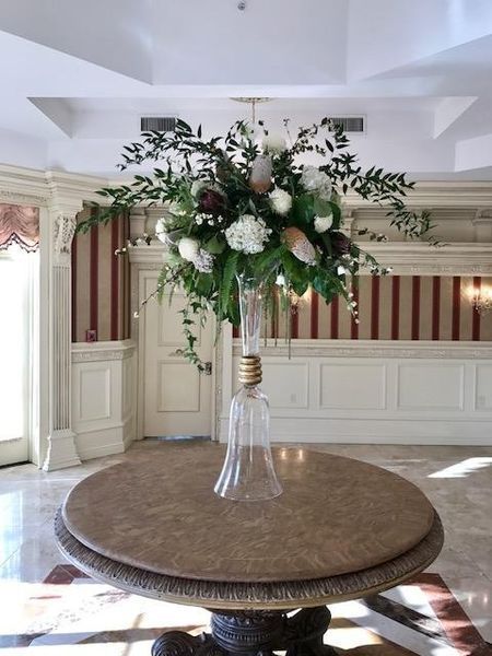 A vase filled with flowers is on a table in a room