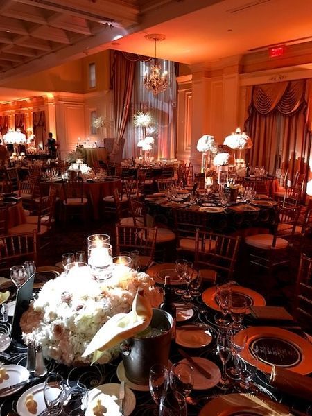 A large room with tables and chairs set up for a party