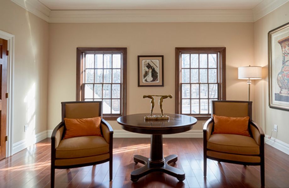 A living room with two chairs and a table