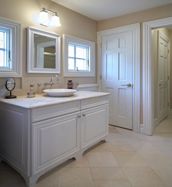 A bathroom with two sinks and two mirrors