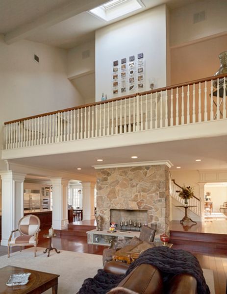 A living room with a fireplace and a balcony