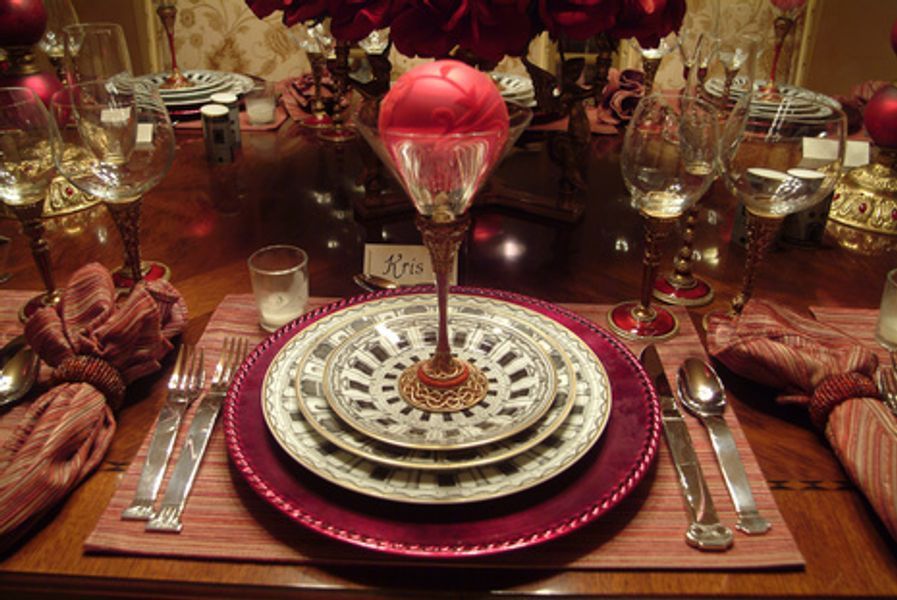 A place setting with plates and a martini glass with a name tag that says ann