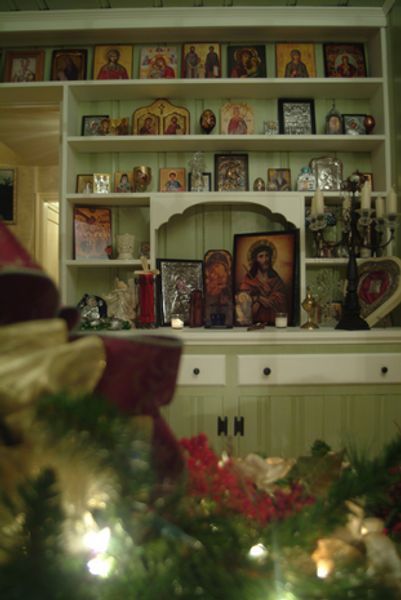 A shelf with icons on it and a christmas tree in the foreground