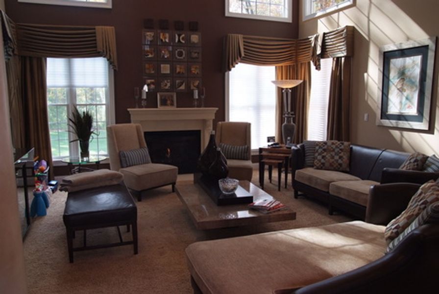 A living room with a couch and chairs and a fireplace