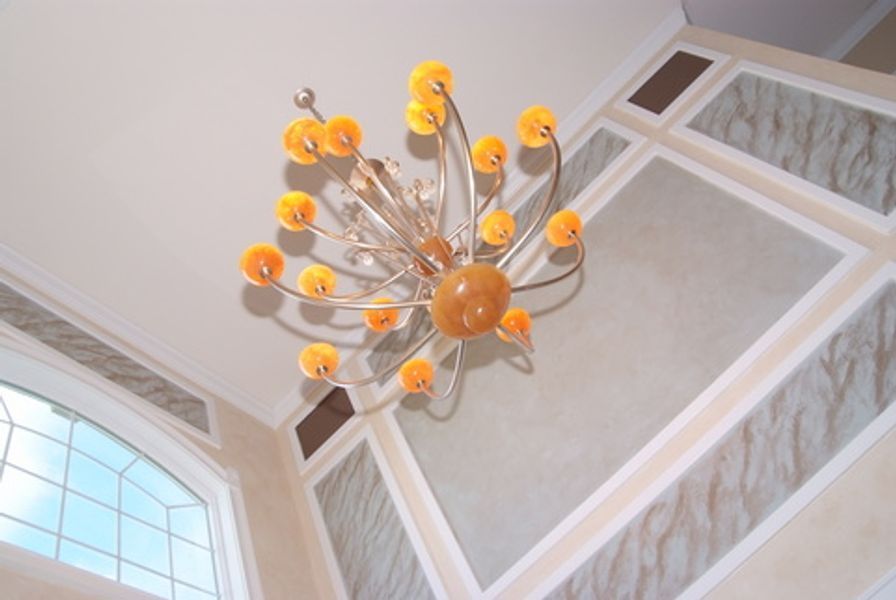 A chandelier is hanging from the ceiling in a room