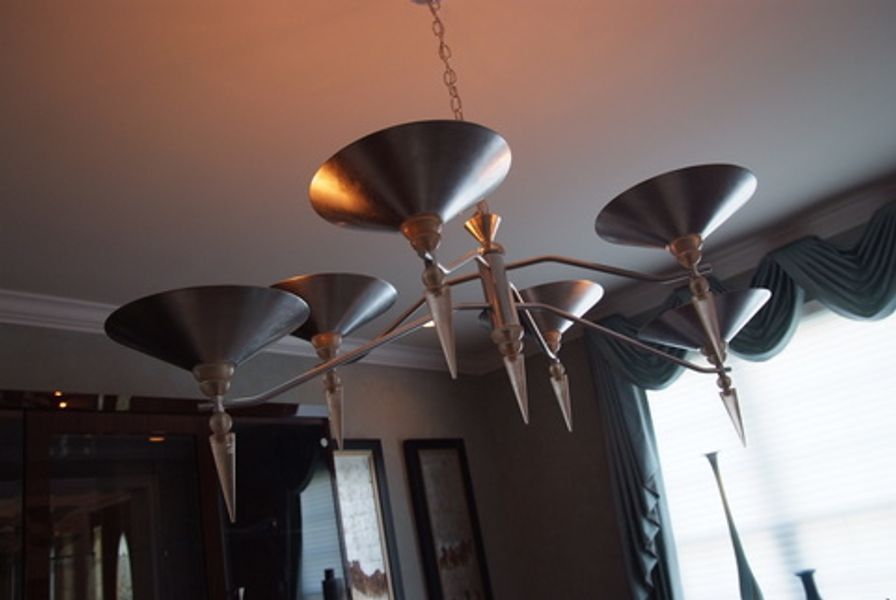 A chandelier is hanging from the ceiling in a room