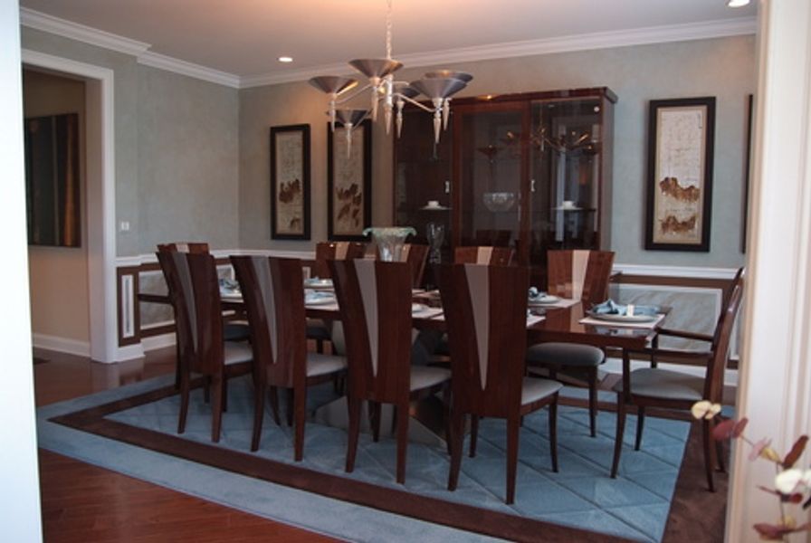 A dining room with a long table and chairs