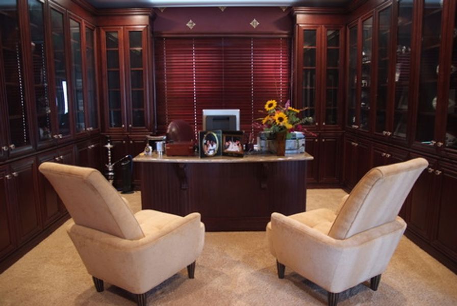 A home office with two chairs and a desk