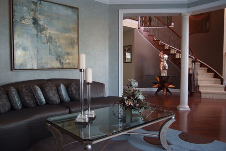 A living room with a couch and a glass coffee table