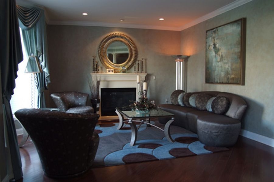 A living room with a couch and chairs and a fireplace