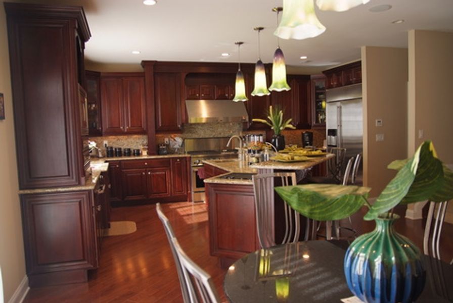 A kitchen with wooden cabinets and stainless steel appliances