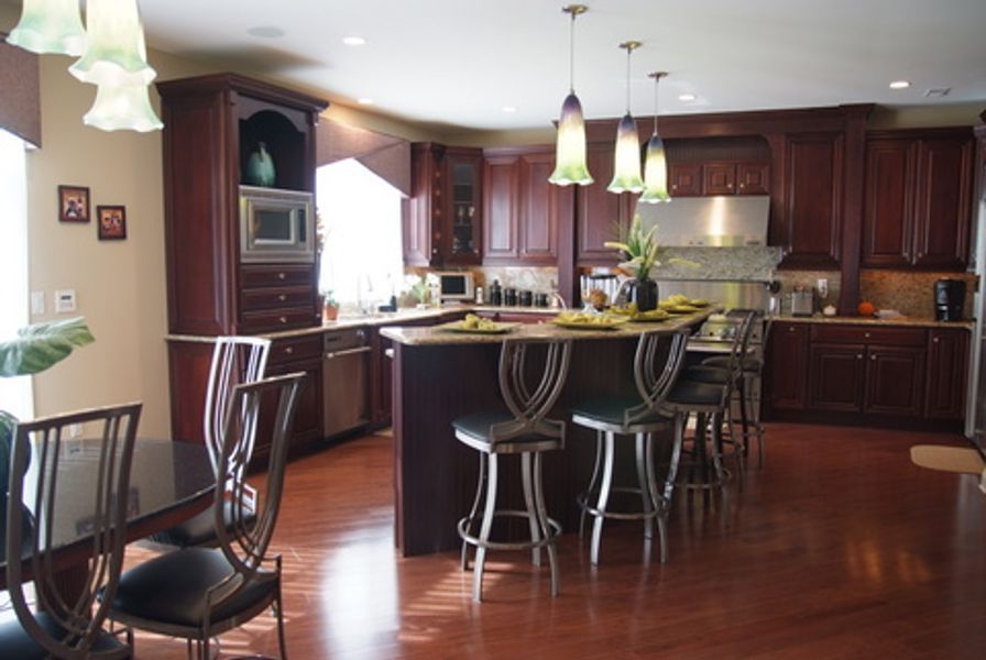 A kitchen with a large island and a table and chairs