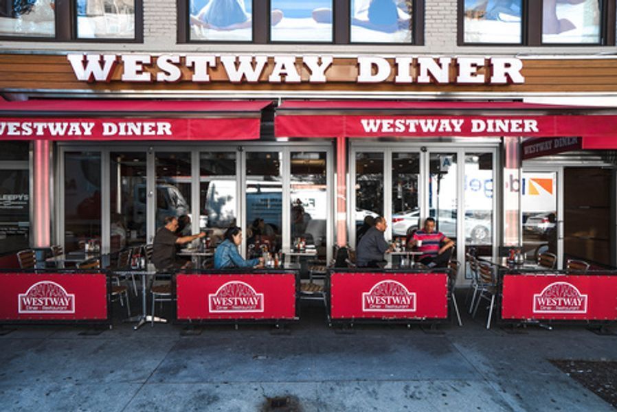 A restaurant called westway diner with people sitting outside